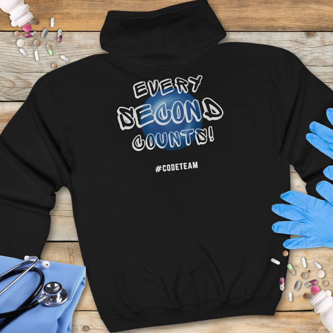 Black hoodie with 'Every Second Counts! #CODETEAM' text on a wooden surface with medical supplies.