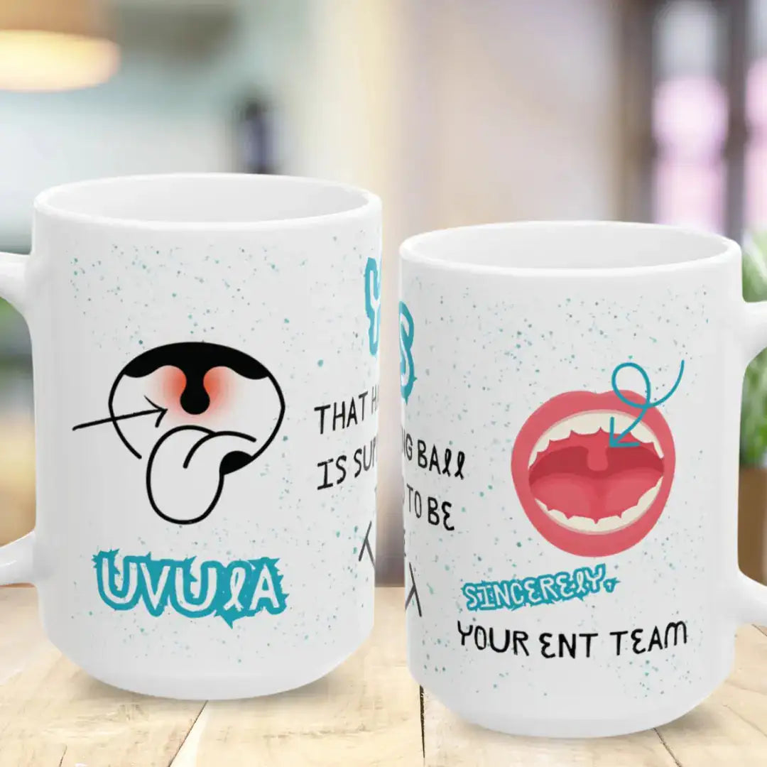 Two white mugs with humorous mouth and uvula designs and 'Your ENT Team' text on a wooden surface.
