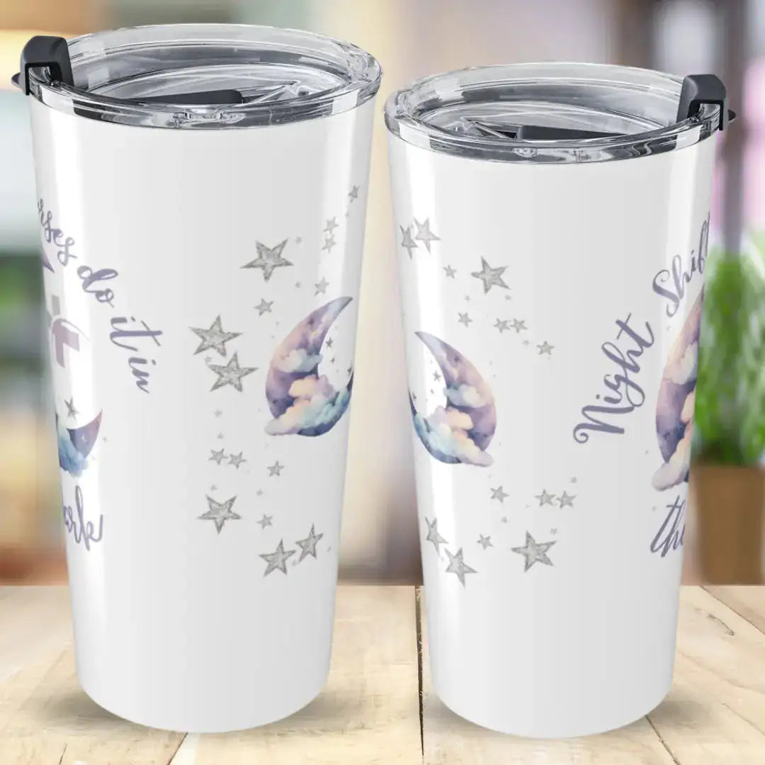 Two white stainless steel tumblers showing front and back views with 'Night Shift Nurses Do It In The Dark' script text, decorated with watercolor crescent moon and scattered silver star graphics, on a wooden desk background.