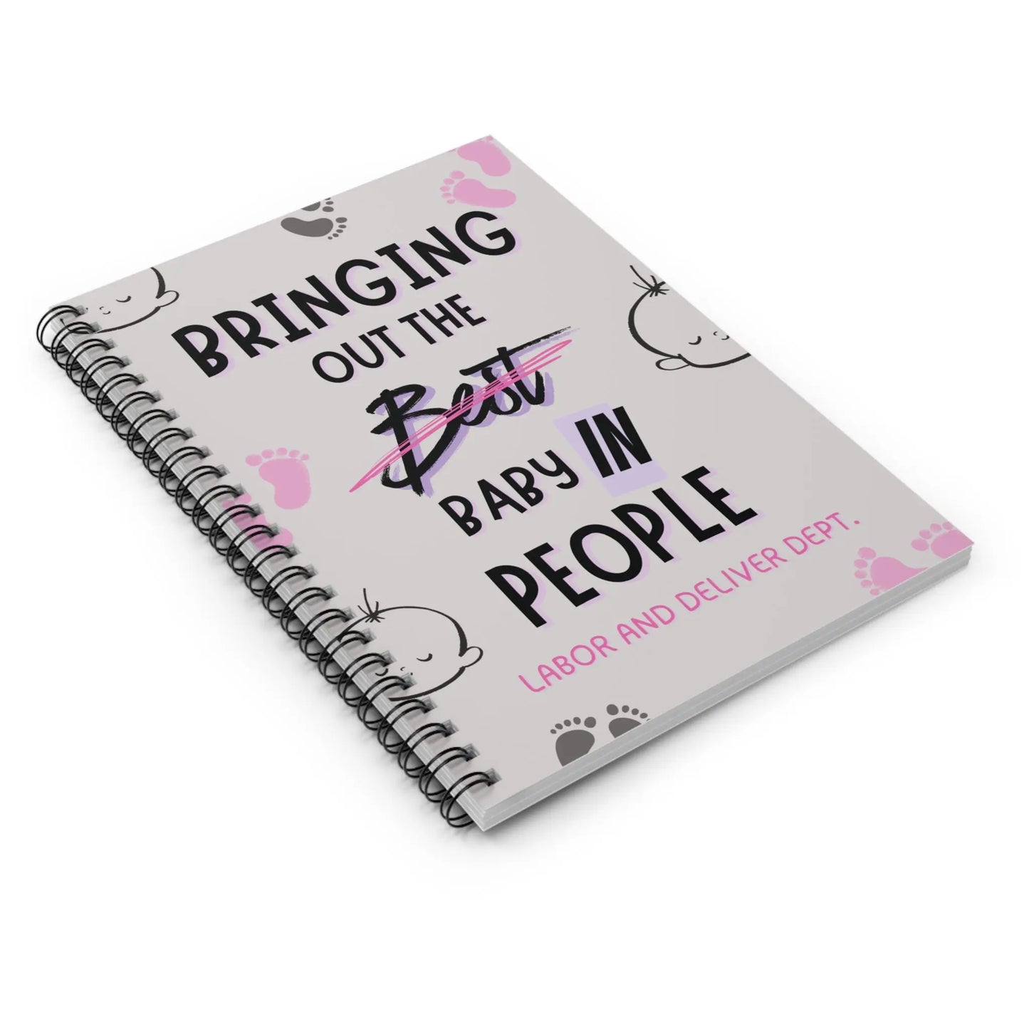 Obstetrics notebook with 'Bringing Out The Baby In People' quote on a white baclground