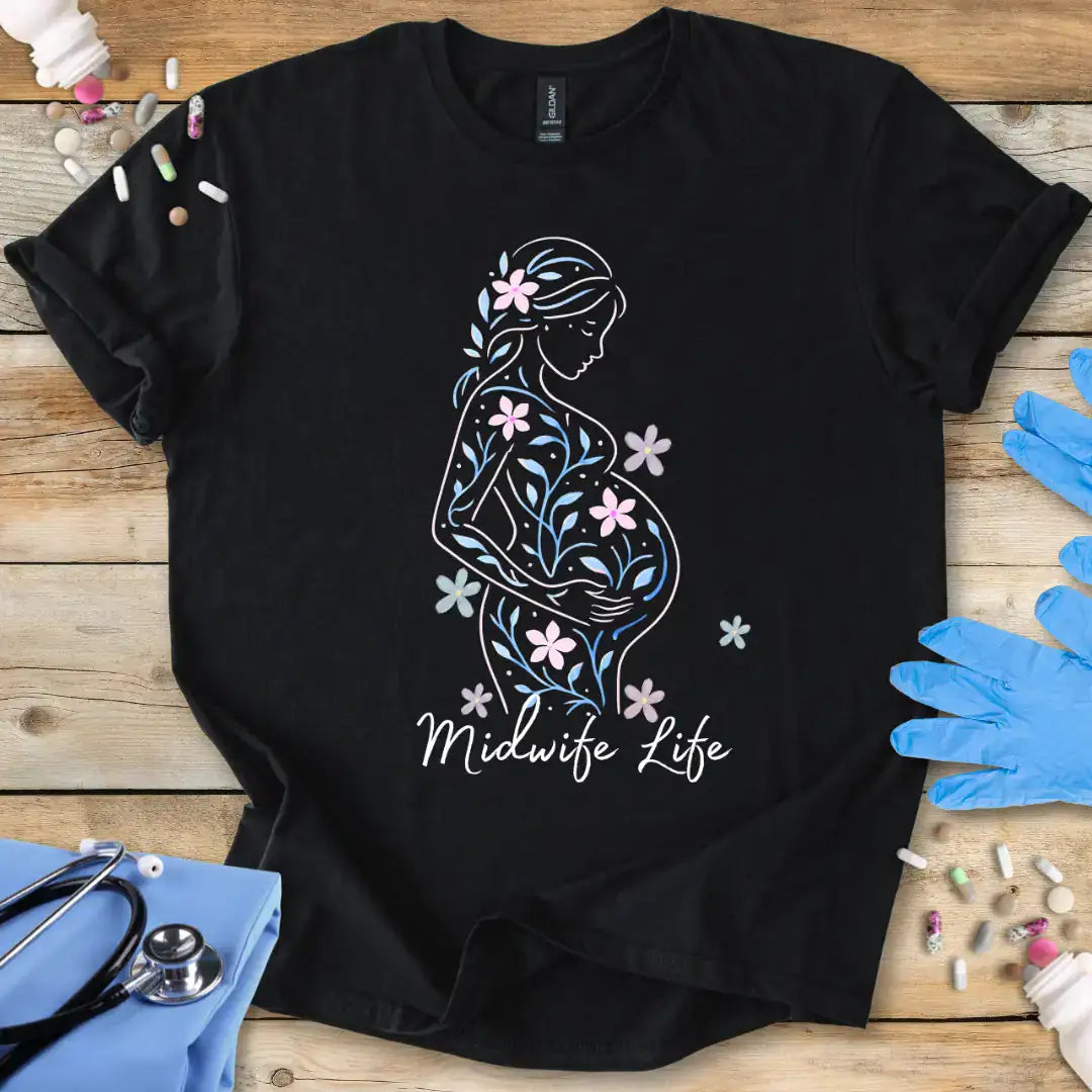 Black t-shirt with a graphic design of a pregnant woman silhouette and 'Midwife Life' text on a wooden surface with medical supplies.