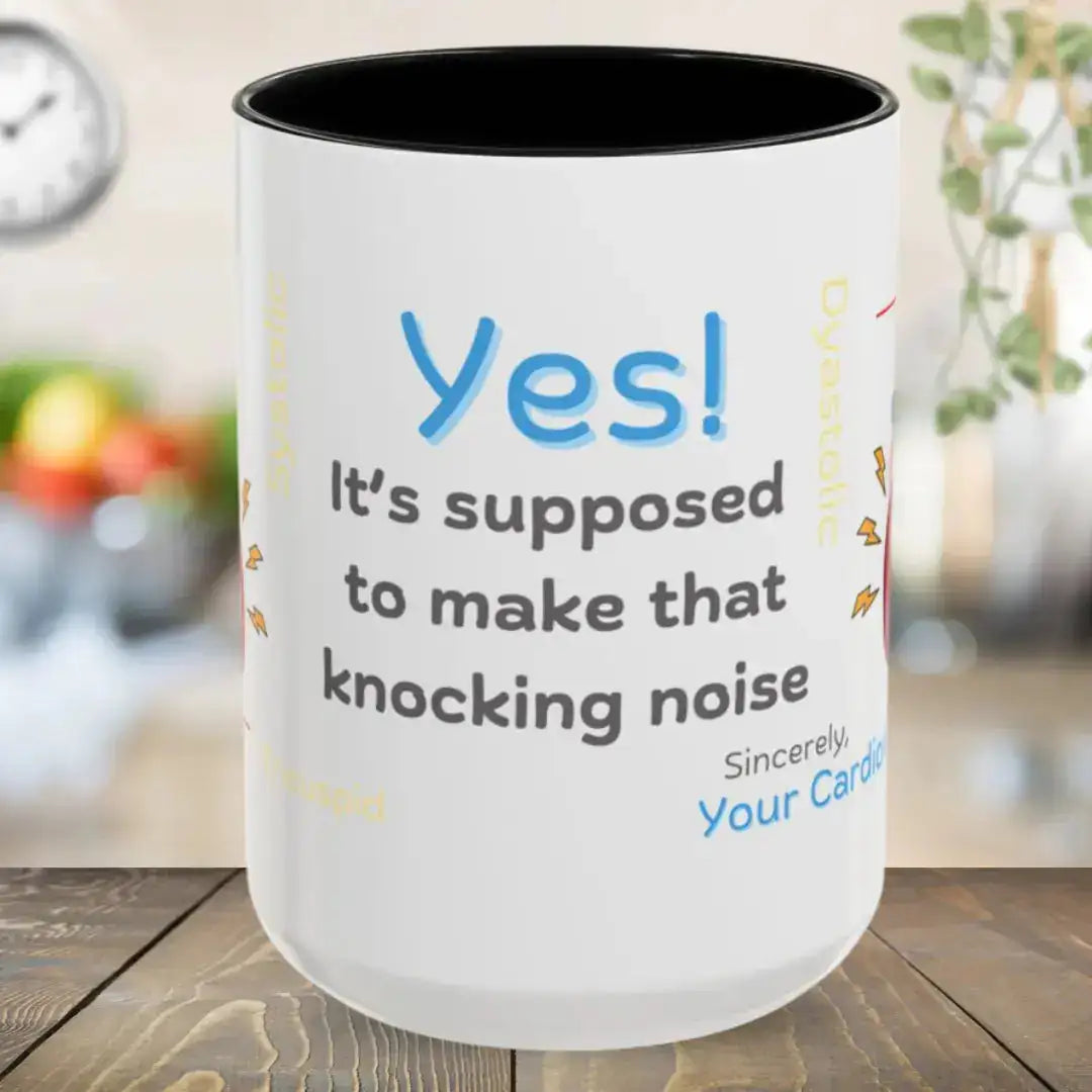 Ceramic white mug with funny 'Yes, It's Supposed To Make That Noise' text and black interior on a wooden surface
