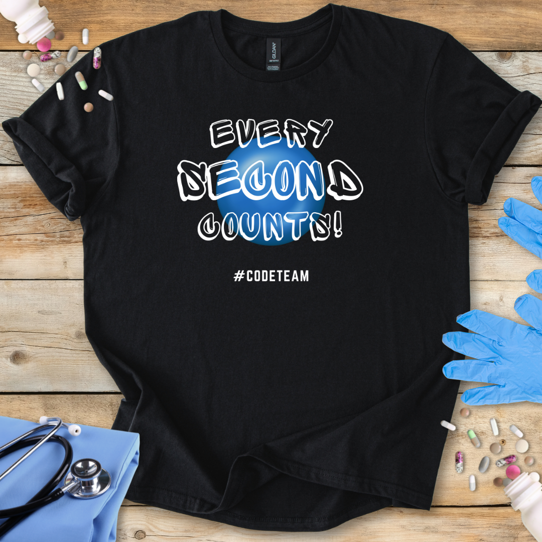 Black t-shirt with 'Every Second Counts! #CODETEAM' text on a wooden surface with medical supplies.