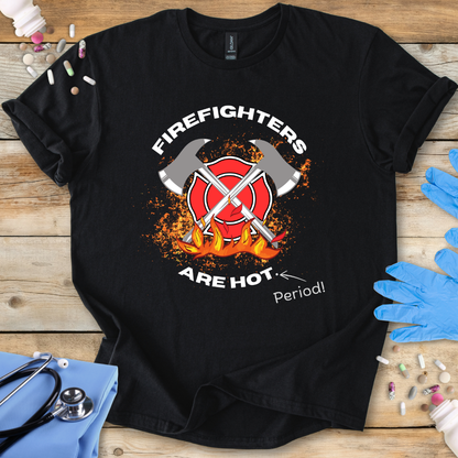 Black t-shirt with firefighter graphic and text on a wooden surface with medical supplies.