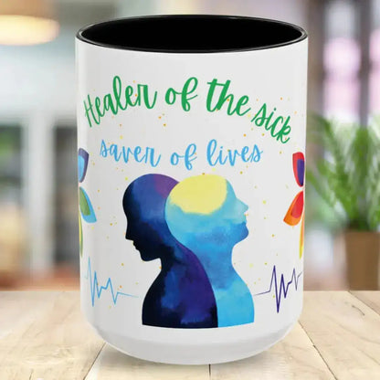 Mug with colorful design and text 'Healer of the sick, savior of lives' on a blurred background