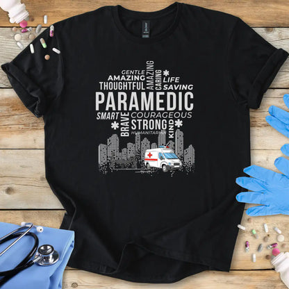 Black t-shirt with white paramedic-themed design on a wooden surface with medical accessories.