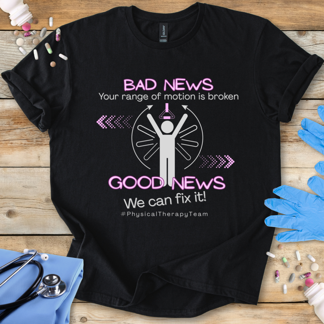 Black t-shirt with a funny physical therapy themed text on a wooden surface with medical supplies.