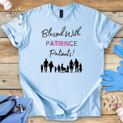Light blue t-shirt with 'Blessed With Patients Not Patience!' text and family icons on a wooden surface with medical items.