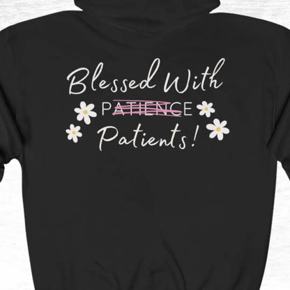Black medical hoodie with white text 'Blessed With Patience' and flower design on a white background