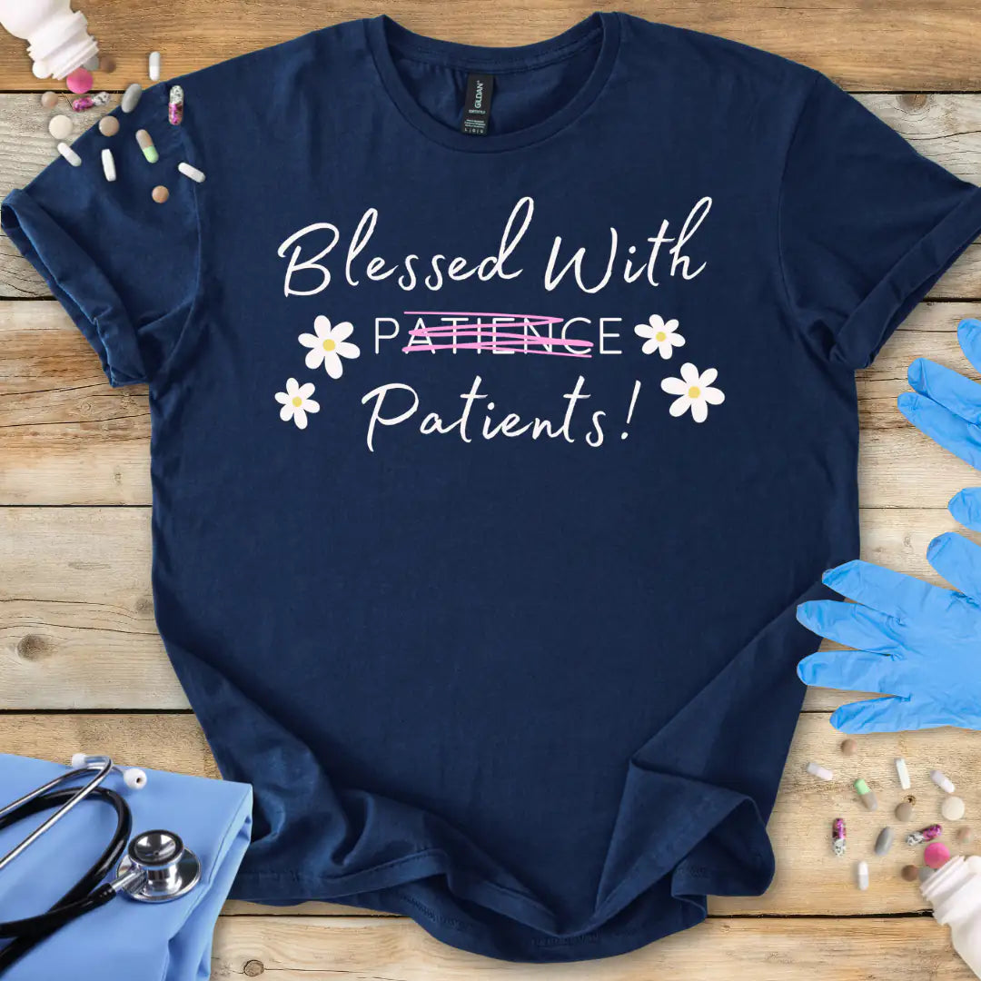 Navy blue t-shirt with 'Blessed With Patients Not Patience!' text on a wooden surface with medical accessories.