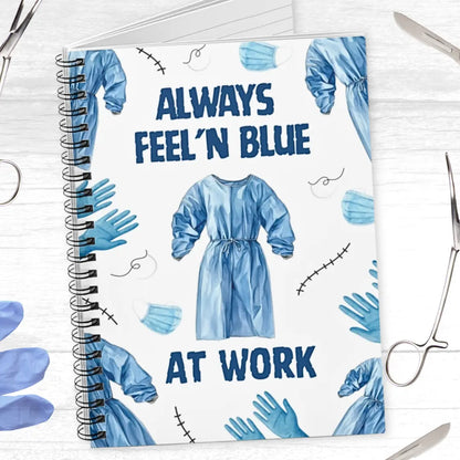 Surgery spiral notebook with blue medical-themed design and text 'Always Feel 'N Blue At Work' and surgical instruments on a white background.