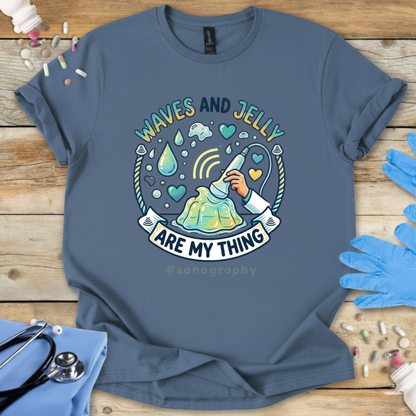 Blue t-shirt with 'Waves and Jelly are my thing' sonography 
design on a wooden surface with medical supplies.