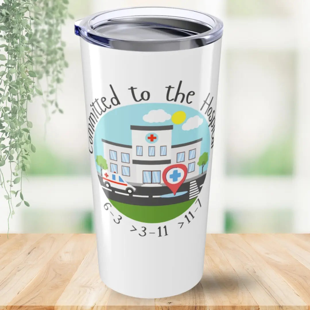 Tumbler with a graphic of a hospital and text 'Committed to the Hospital' on a wooden surface.
