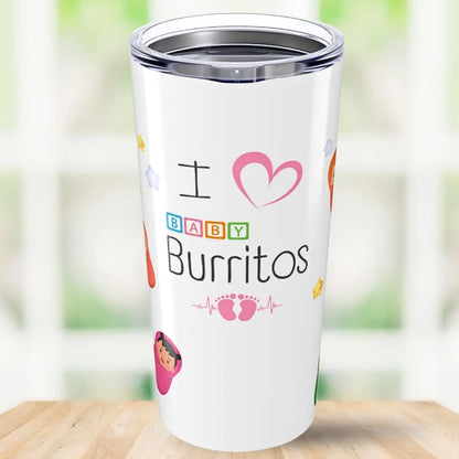 White tumbler with colorful text 'I Love Baby Burritos' and graphics on a wooden surface with a blurred green background.