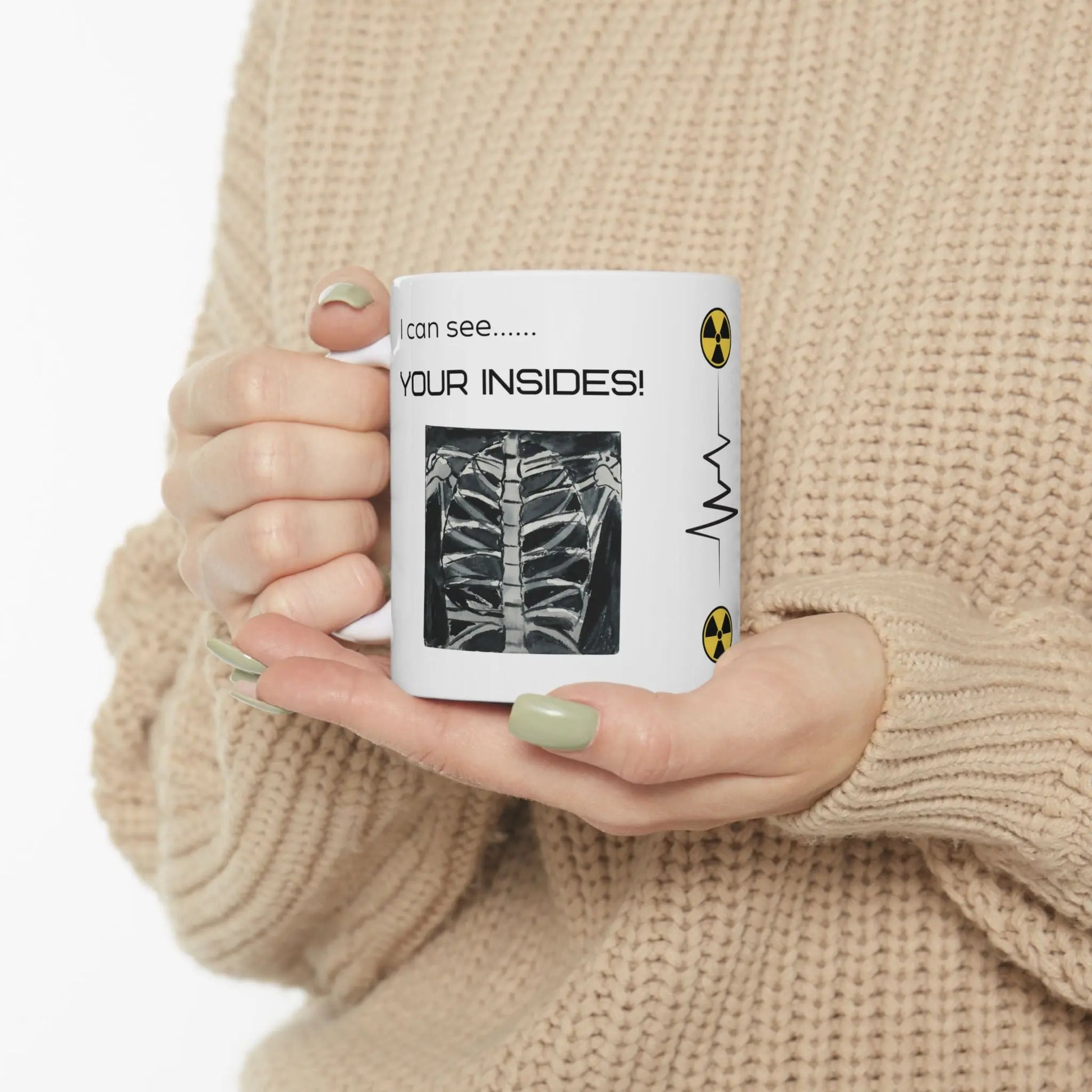 Person holding a mug with a humorous radiology design and 'I Can See Your Insides' text.