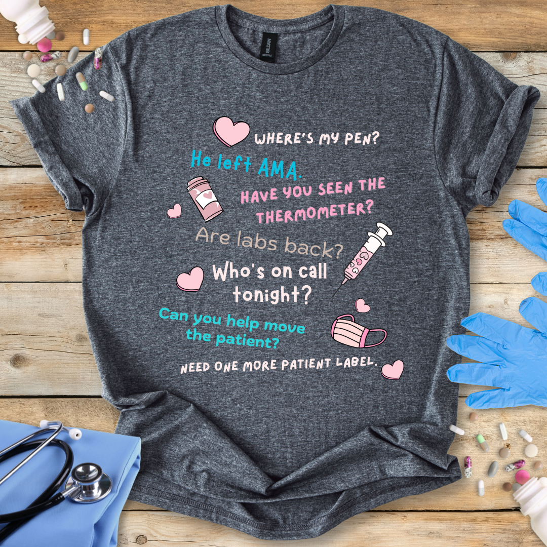 Gray t-shirt with medical-themed text and graphics on a wooden surface with medical accessories.