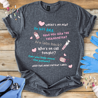 Gray t-shirt with medical-themed text and graphics on a wooden surface with medical accessories.