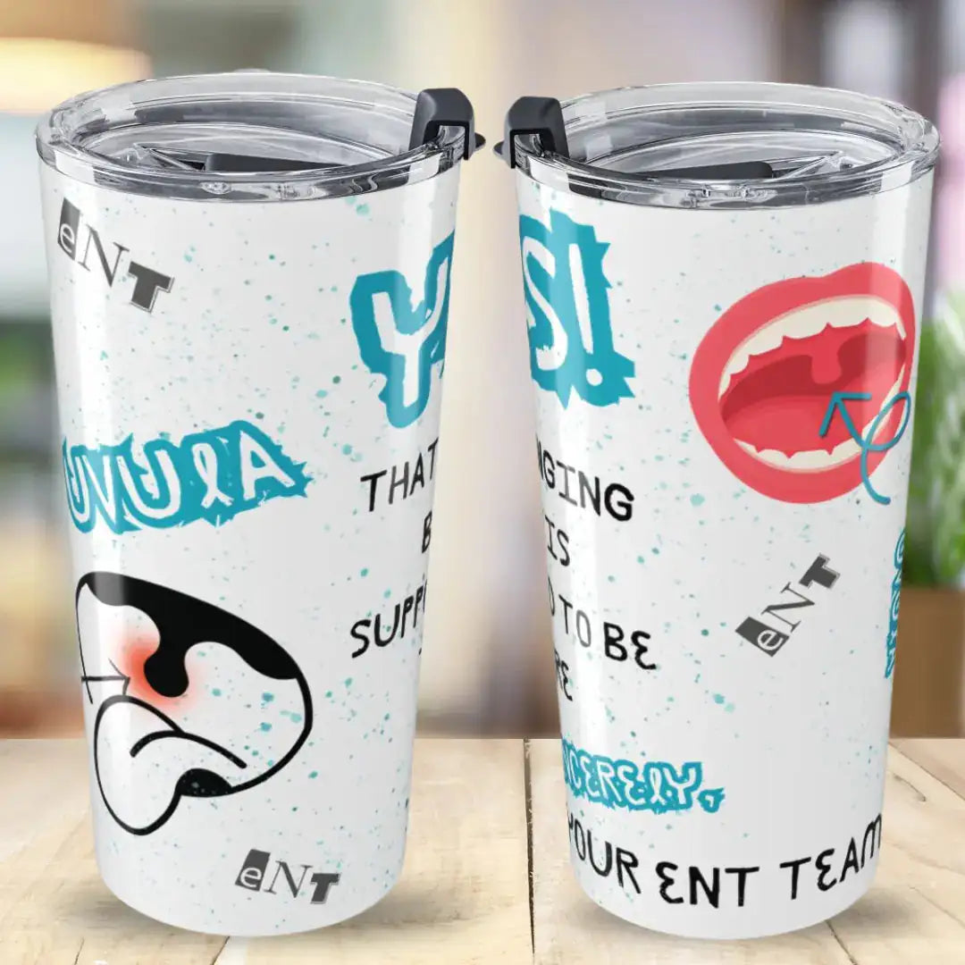 Two white tumblers with colorful designs and text on a wooden surface.