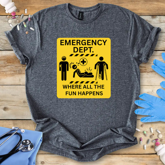 Gray t-shirt with a funny yellow emergency department sign graphic on a wooden surface with medical-themed items.