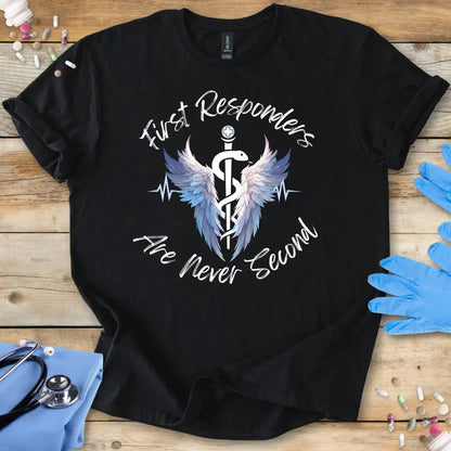 Black t-shirt with 'First Responders Are Never Second' design on a wooden surface with medical accessories.