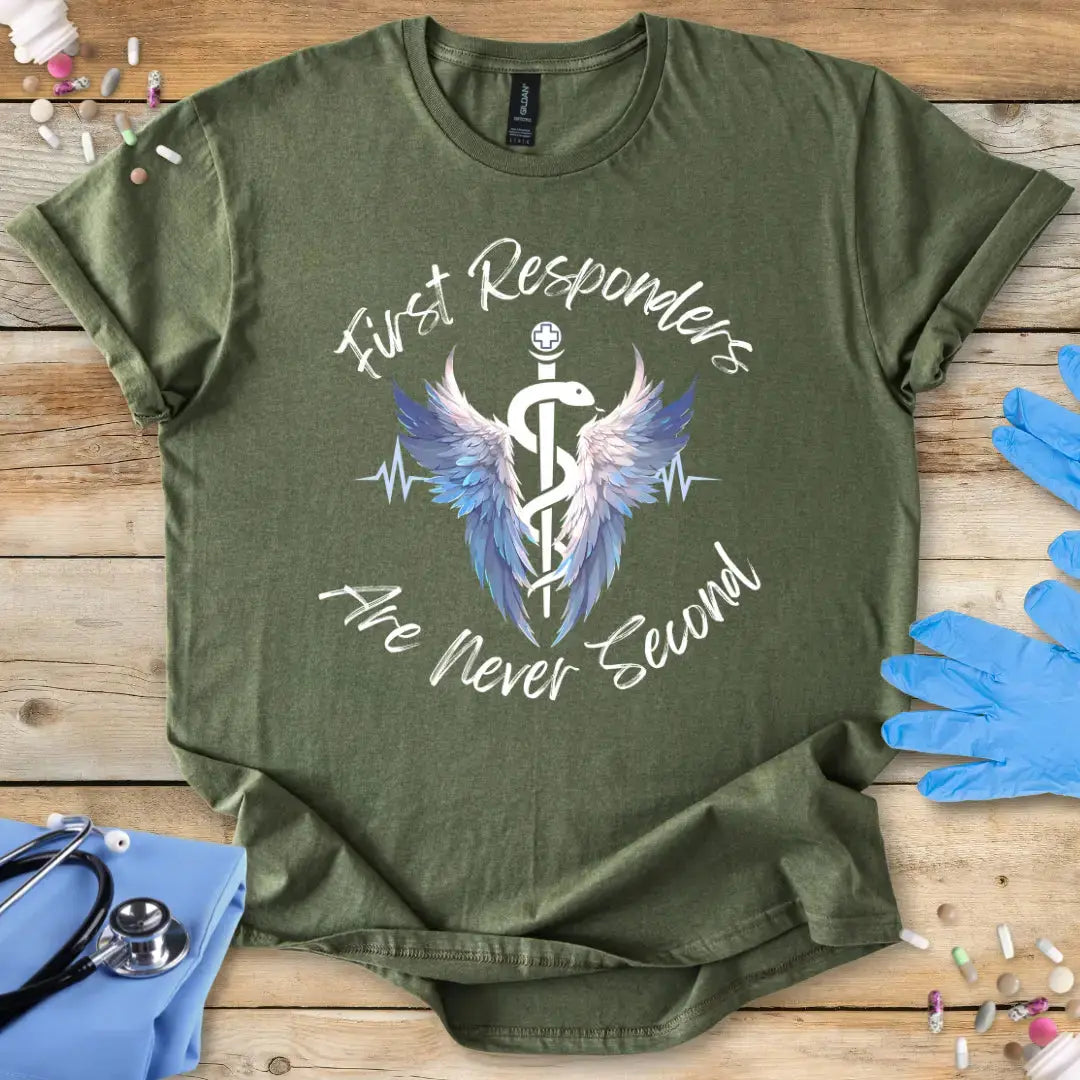 Green med t-shirt with 'First Responders Are Never Second' design on a wooden surface with medical supplies.
