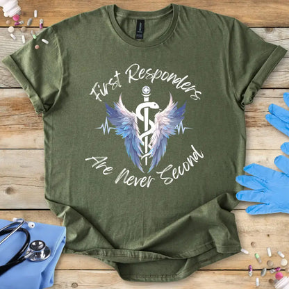 Green med t-shirt with 'First Responders Are Never Second' design on a wooden surface with medical supplies.