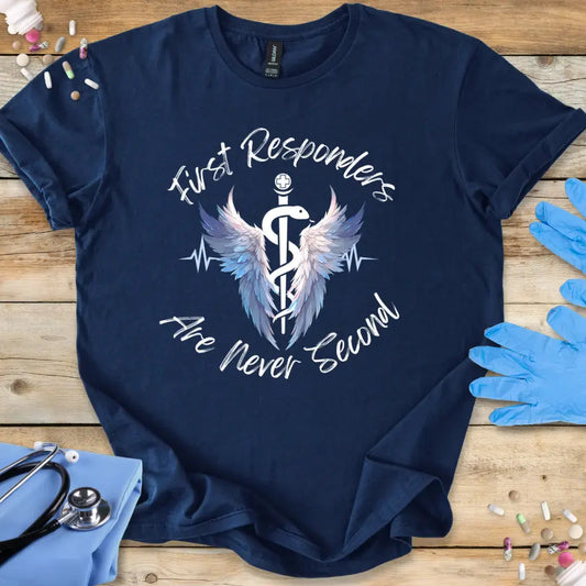 Navy blue t-shirt with 'First Responders Are Never Second' design on a wooden surface with medical accessories.