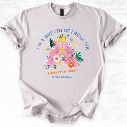 Gray t-shirt with a colorful graphic and I'm A Breath Of Fresh Air' text on a white background