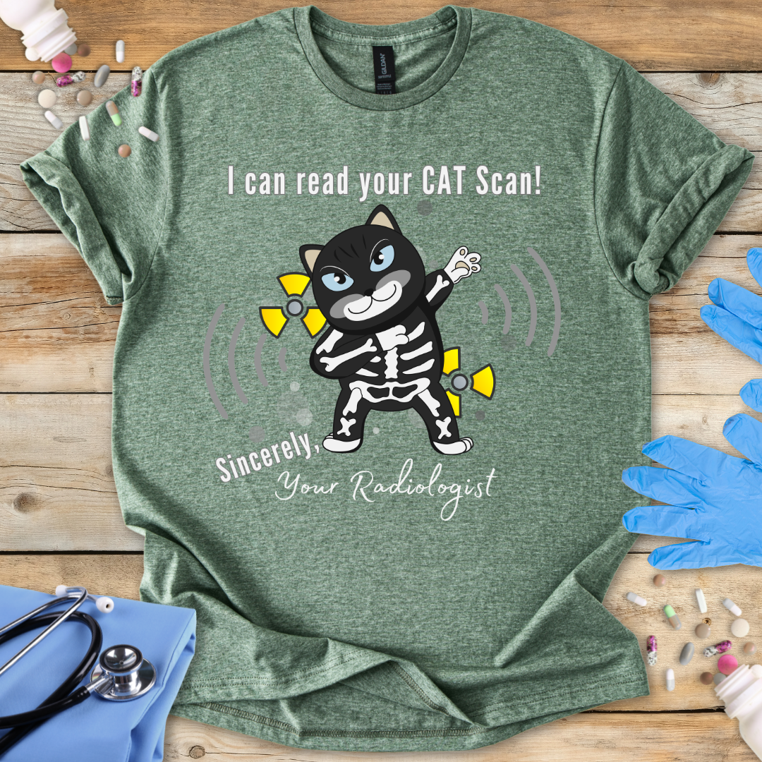 Military Green t-shirt with cartoon cat in an x-ray and 'I can read your cat scan your radiologist' text on a wooden surface with medical-themed props.