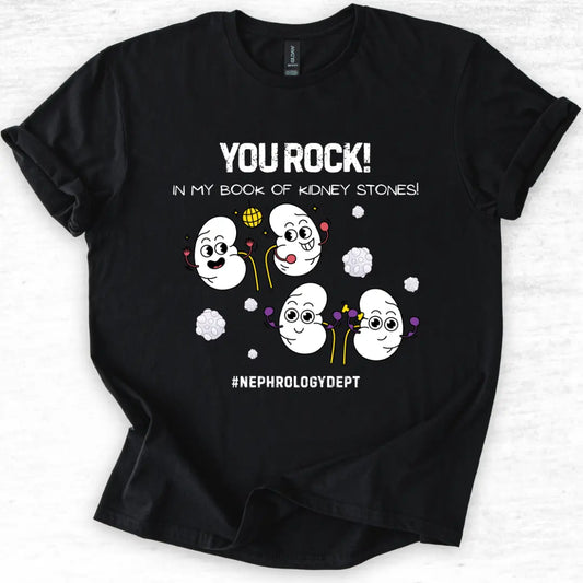 Black t-shirt with cartoon kidneys and 'You Rock In My Book Of Kidney Stones' text on a light gray background