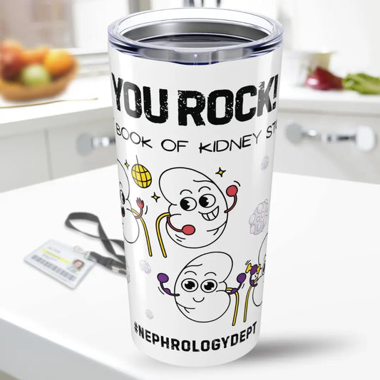 Tumbler with cartoon kidney design and 'You Rock In My Book Of Kidney Stones' text on a kitchen counter