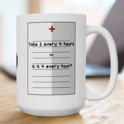 White mug with a humorous medication schedule design on a wooden surface.