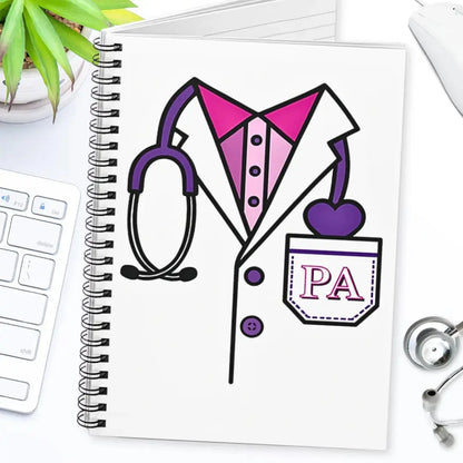 Notebook with a PA (Physician Assistant) illustration on a desk with a stethoscope and plant.