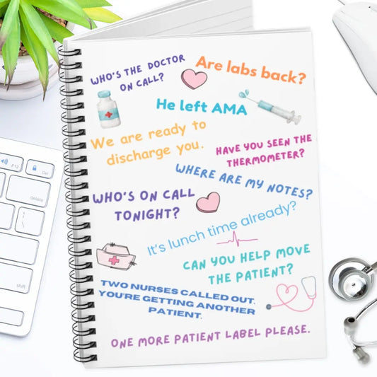 Notebook with medical-themed text and illustrations on a desk with a keyboard and stethoscope.