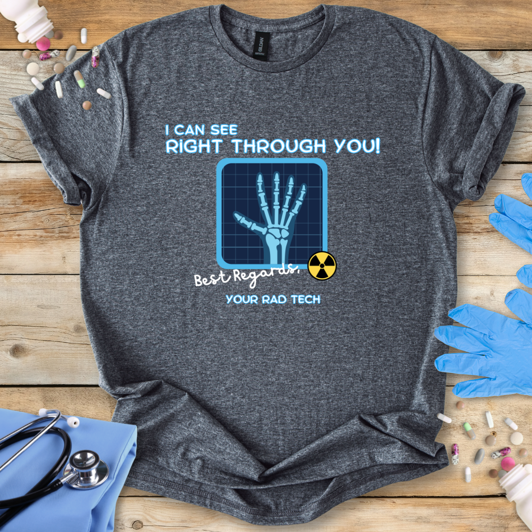 Soft t-shirt with radiology themed graphic and 'I can see right through you' text on a wooden surface with medical gloves.