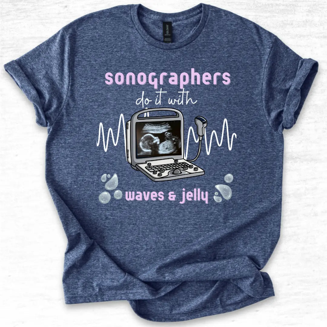 Blue t-shirt with ultrasound graphic and text 'Sonographers do it with waves & jelly' on a light gray background