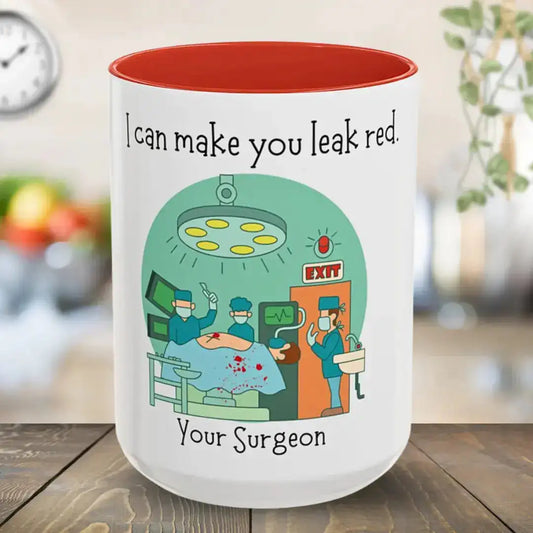 White mug with red interior, featuring a cartoon surgeon design and text, on a wooden surface.