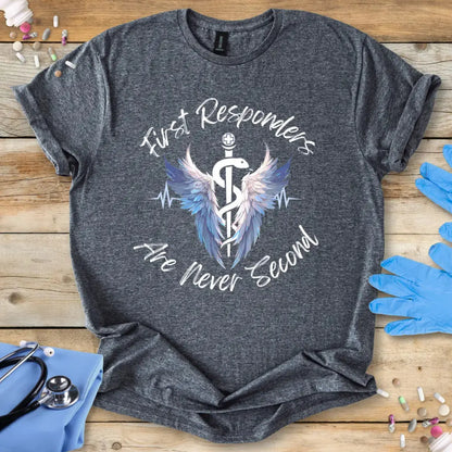 Gray t-shirt with 'First Responders Are Never Second' design on a wooden surface with gloves and stethoscope.