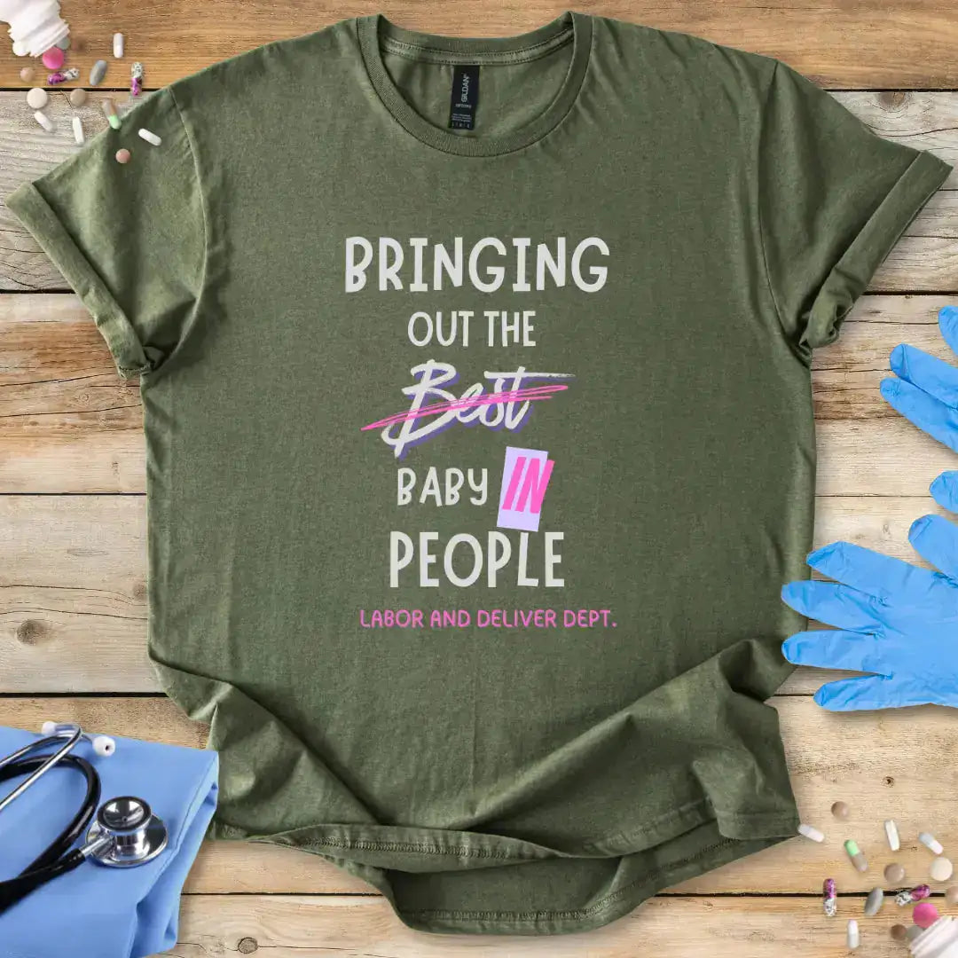 Green t-shirt with humorous text on a wooden surface with medical-themed items.