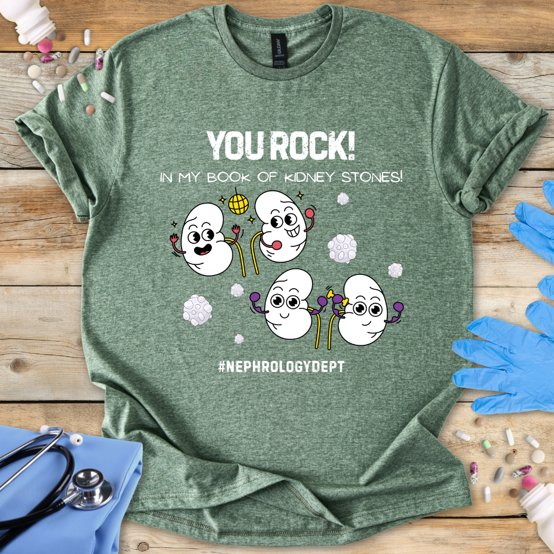 Military Green t-shirt with cartoon kidneys and 'You rock in my book of kidney stones, nephrology dept.' text on a wooden surface with medical accessories.