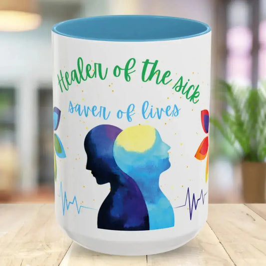 Mug with colorful design and 'Healer Of The Sick' text on a wooden surface