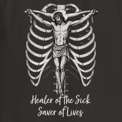 Black shirt with illustration of crucified Jesus and 'Healer of the Sick, Saver of Lives' logo on a dark background