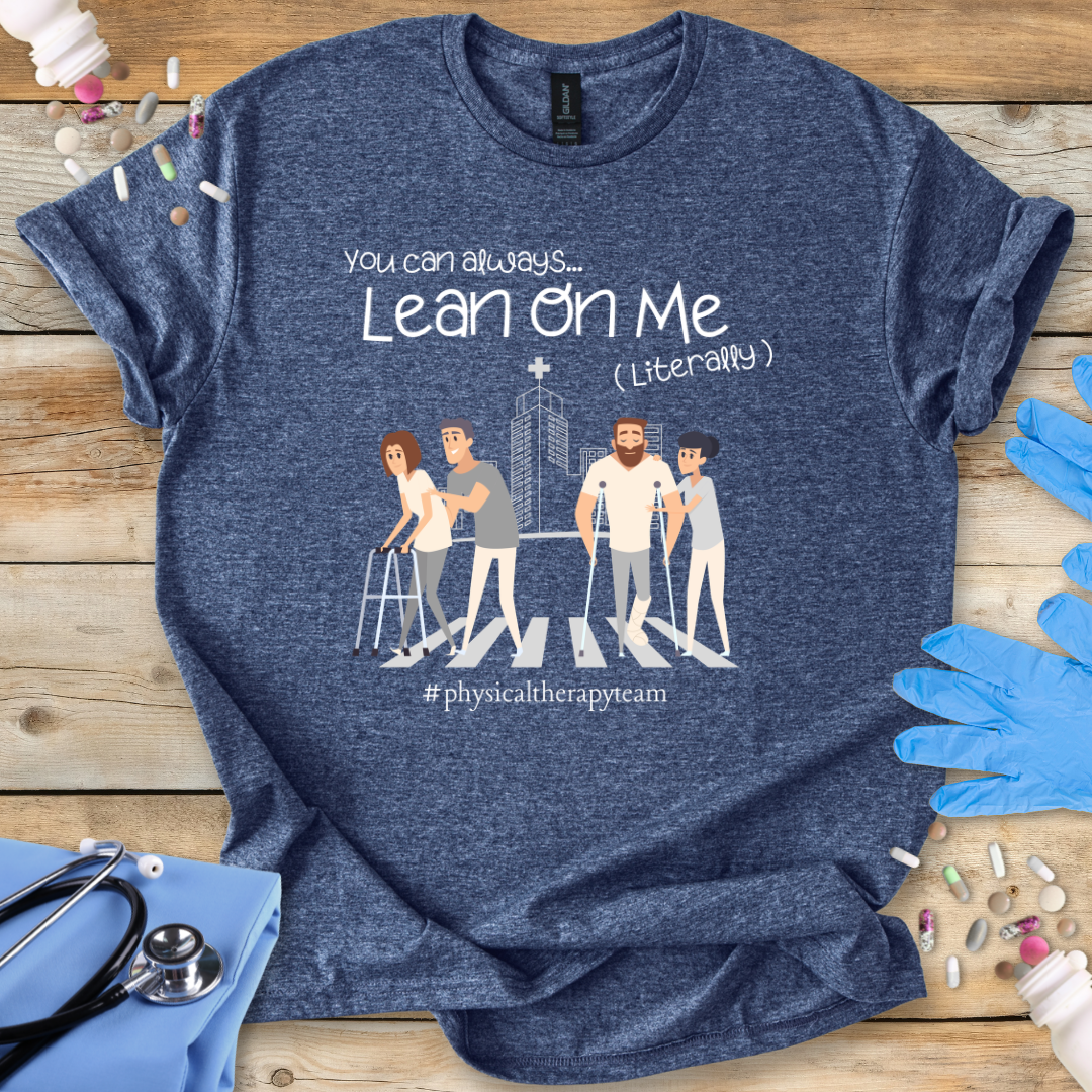 Blue med t-shirt with graphic design and text on a wooden surface with medical accessories.