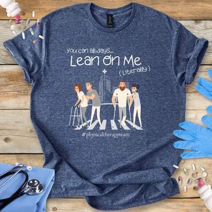 Blue med t-shirt with graphic design and text on a wooden surface with medical accessories.