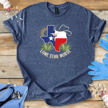 Blue t-shirt with 'Lone Star Nurse' design on a wooden surface with medical supplies.