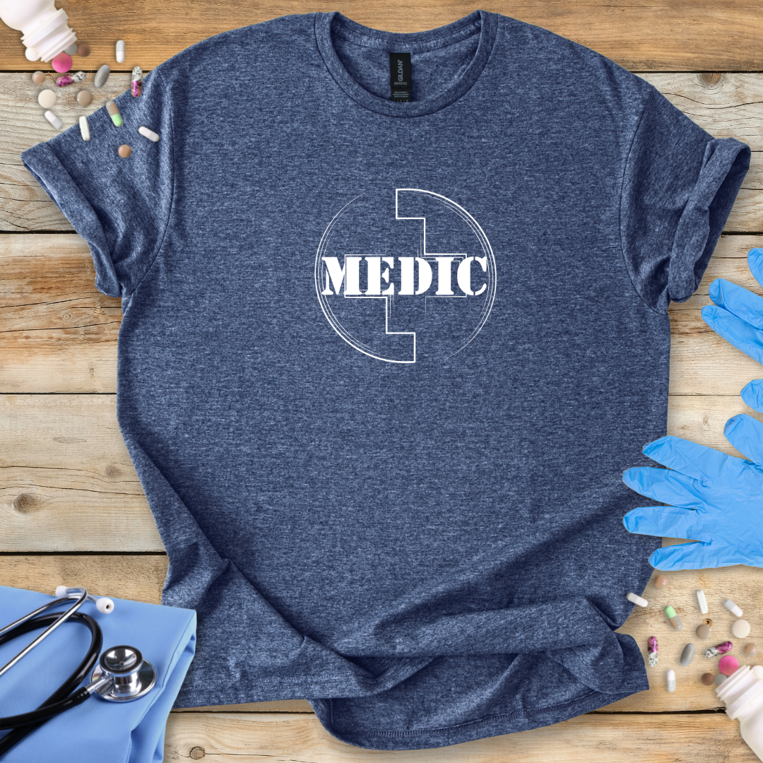 Navy t-shirt with 'MEDIC' logo on a wooden surface with medical supplies.