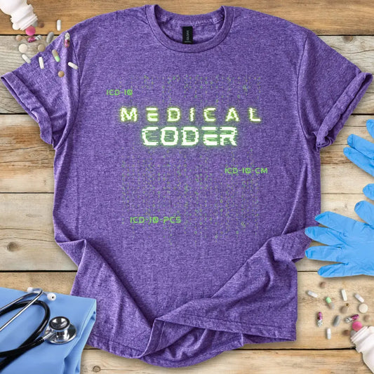 Purple t-shirt with 'Medical Coder' text on a wooden surface with medical items.