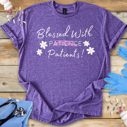 Purple medical themed t-shirt with 'Blessed With Patience Patients!' text on a wooden surface with medical supplies.