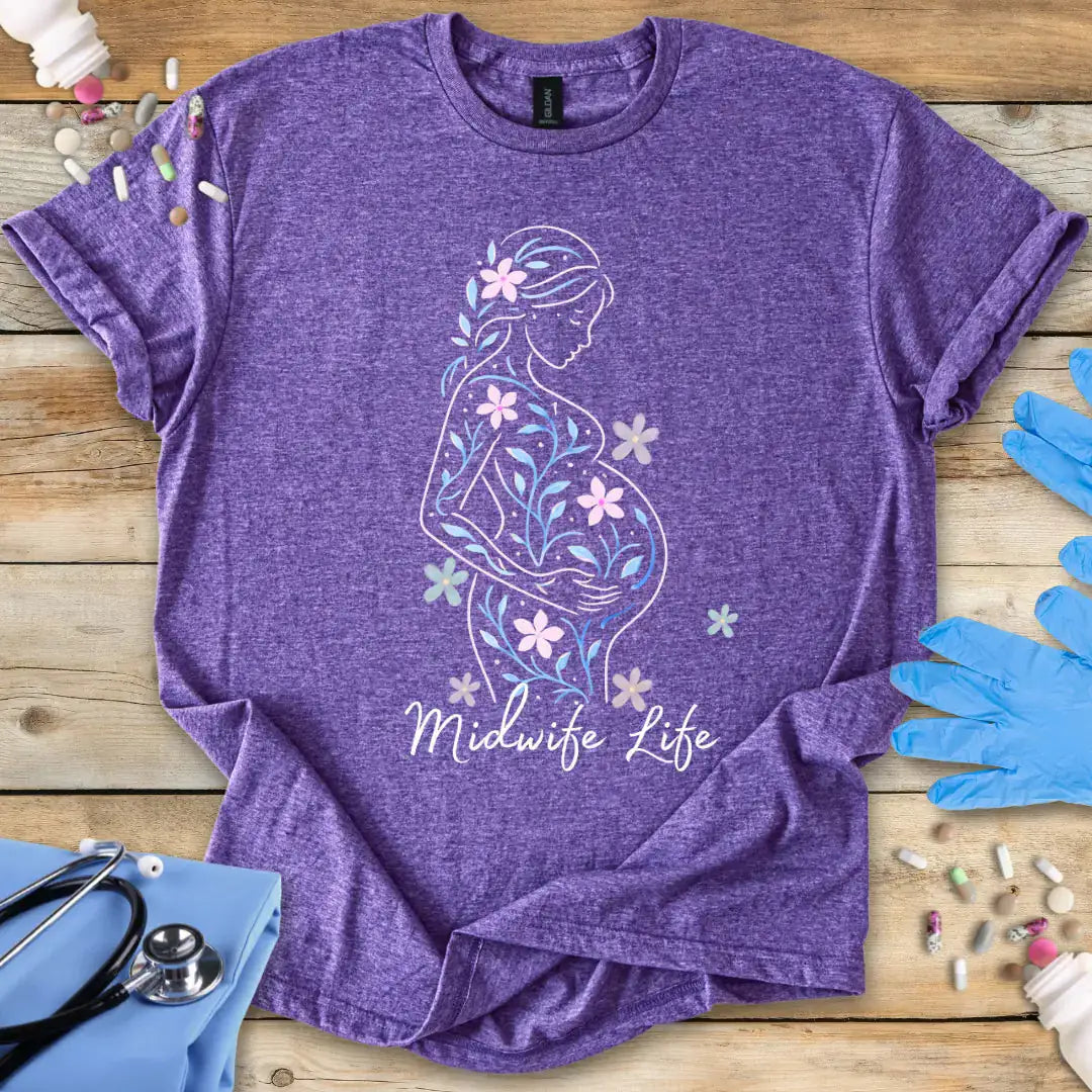 Heather Purple t-shirt with a pregnant silhouette and 'Midwife Life' text on a wooden surface with medical supplies.