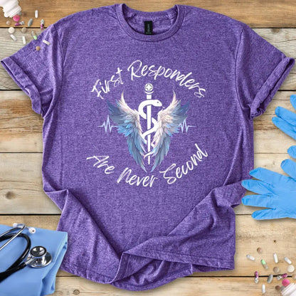 Purple med t-shirt with 'First Responders Are Never Second' design on a wooden surface with medical-themed items.